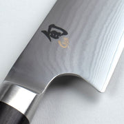 Shun | Classic Kiritsuke, 8 inches, showcases a Damascus-style blade with a black and gold logo, highlighting its versatile design for slicing and push cuts.