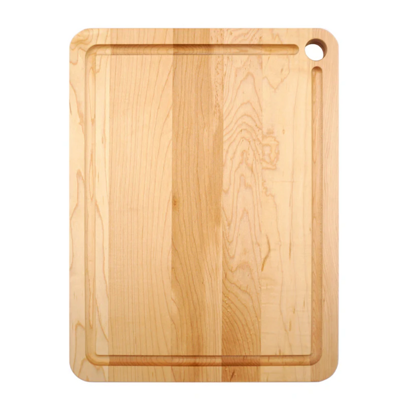J.K. Adams Maple Prep Cutting Board with Juice Groove, showcasing a wooden surface with a distinctive hole, ideal for kitchen prep.