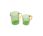 Great Jones | Beyond Measure 4-Cup - Broccoli-Butternut, a borosilicate glass measuring cup with clear measurements, ideal for precise cooking and serving.