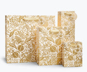 Rifle Paper Co. - Pomegranate Gift Bag set with gold botanical pattern, varied sizes, gold ribbon handles, and tags, ideal for elegant gift-giving from Athens Cooks.
