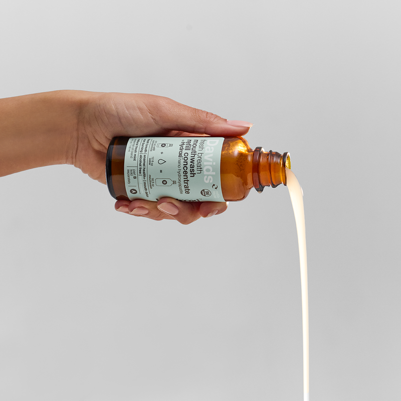 Davids Hydroxi™ fresh breath mouthwash concentrate in amber glass bottle, non-burning, alcohol-free, mint oil blend, enamel health focus, refillable, eco-friendly, for sustainable oral care.