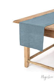 MagicLinen - Linen table runner on a wooden table, enhancing decor and protection. Available in various colors and sizes at Athens Cooks, ideal for kitchen aesthetics.