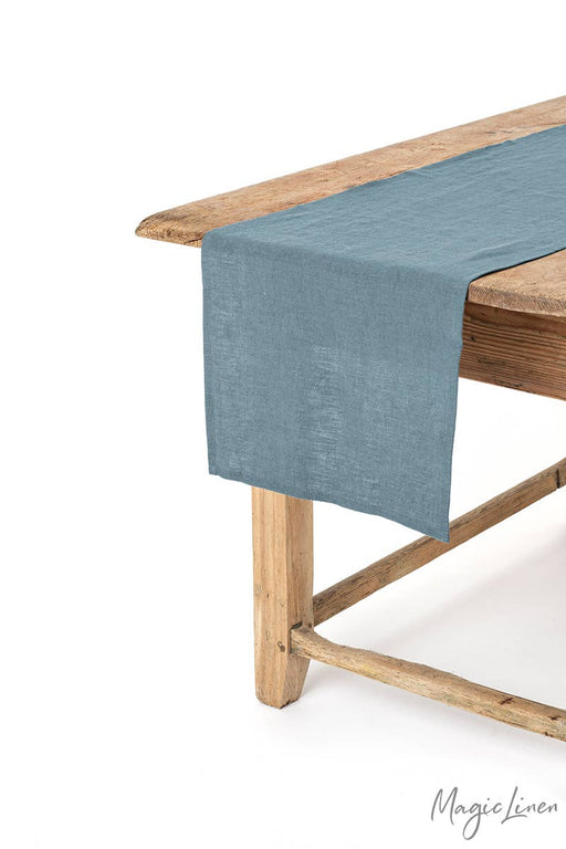 MagicLinen - Linen table runner on a wooden table, enhancing decor and protection. Available in various colors and sizes at Athens Cooks, ideal for kitchen aesthetics.