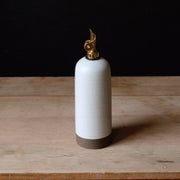 Rose Line Pottery - Oil Bottle - White - 22 Ounces, features a gold-plated lighter mechanism atop a handcrafted ceramic vessel with a raw-clay base, ideal for oils and syrups.