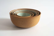 RachaelPots | Set of Three Nesting Bowls - Robin's Egg Blue features hand-thrown ceramic bowls with sandy brown exteriors and mint-green interiors, perfect for versatile kitchen use.