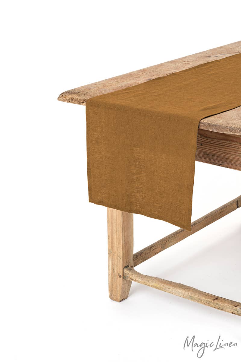 MagicLinen - Linen table runner on wooden table, showcasing its texture and style, perfect for enhancing kitchen decor.