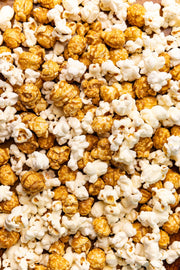 Poppy Hand-Crafted Popcorn - Asheville Mix Artist Bag features a close-up of plain and caramel-coated popcorn, supporting local entrepreneurs with each purchase.