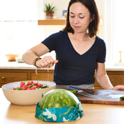 Bee's Wrap - Assorted 3 Pack - Oceans used in preparing a watermelon and cucumber salad in a kitchen, showcasing its practical use in food storage.