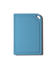 The MK Free Board: Ocean, a sky-blue kitchen cutting board with a textured surface, raised edges, and a corner handle for easy use and storage.