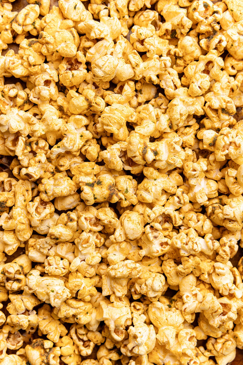Poppy Hand-Crafted Popcorn - Mexican Street Corn Popcorn: A close-up of seasoned popcorn, highlighting its chipotle, cumin, and lime-infused texture, perfect for a flavorful snack adventure.