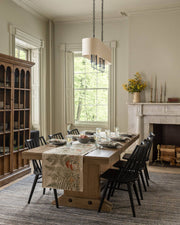Coral & Tusk - Mushrooms and Ferns Bouquet Dinner Napkin displayed on a wooden dining table with a matching table runner, set for an elegant meal.