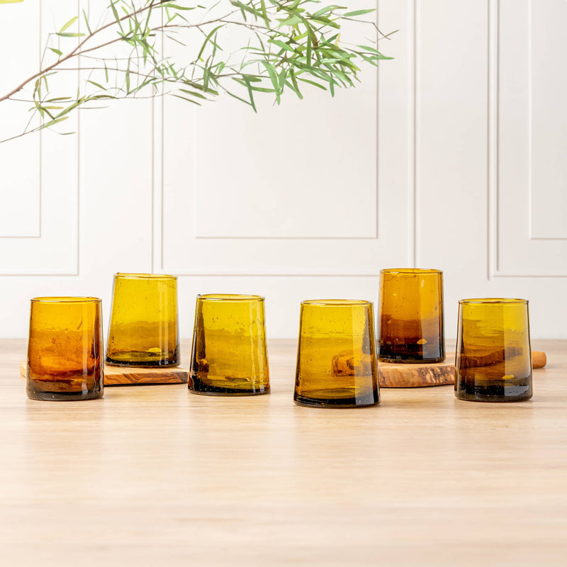 Moroccan Cone Glassware Small - Amber - Set of 6: Hand-blown, cone-shaped glasses with visible bubbles, made from recycled glass, perfect for beverages or as decorative vases.