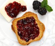 Southern Roots Sisters Triple Berry Jam on whole-grain toast, with a cheese slice, fresh blackberries, and mint. Ideal for breakfast or brunch at Athens Cooks.