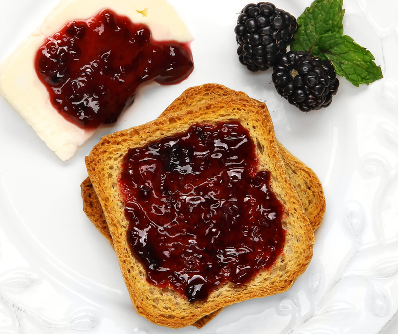 Southern Roots Sisters Triple Berry Jam on whole-grain toast, with a cheese slice, fresh blackberries, and mint. Ideal for breakfast or brunch at Athens Cooks.
