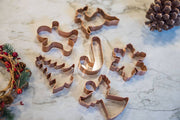 Galley and Fen - Christmas Cookie Cutters - Set of 6 on marble, featuring gingerbread, candy cane, tree, snowflake, angel, reindeer shapes with festive wreath accents.