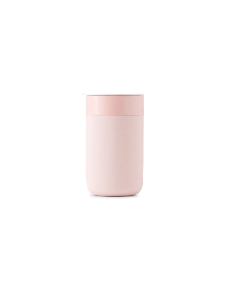 Reusable ceramic mug with pink lid, 16 oz, features a splash-resistant lid and silicone sleeve for grip. Ideal for sustainable coffee drinking.