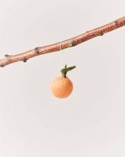 Farmhouse Pottery - Felted Fruit Ornament: Pear displayed on a bare branch, showcasing its handcrafted, fair trade, wool design. Perfect for adding minimalist charm to kitchen decor.