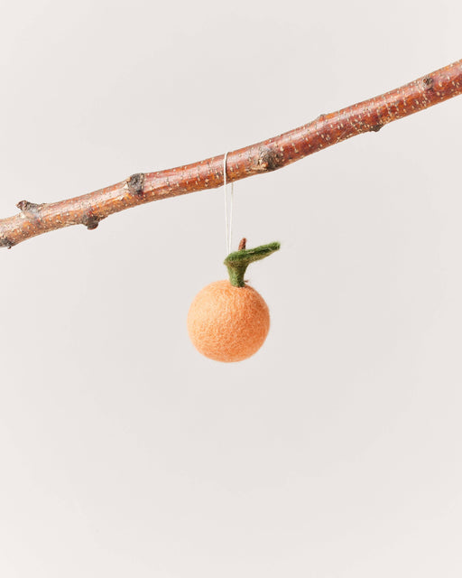 Farmhouse Pottery - Felted Fruit Ornament: Pear displayed on a bare branch, showcasing its handcrafted, fair trade, wool design. Perfect for adding minimalist charm to kitchen decor.