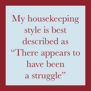 Coaster with humorous text: My housekeeping style is best described as 'There appears to have been a struggle.' From Drinks on Me, adds humor to bar decor.