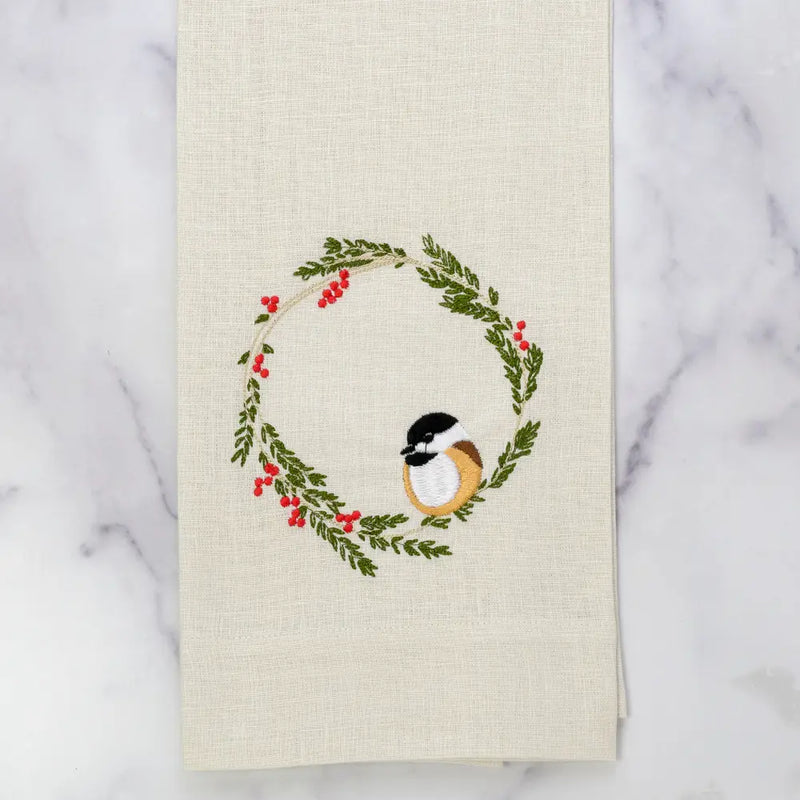 Chickadee Wreath Towel, Cream: 100% linen towel with embroidered winter wreath and chickadee, perfect for adding whimsical charm to your kitchen decor.