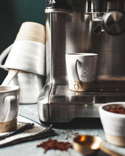 Farmhouse Pottery - Silo Espresso Cup: Single on espresso machine, surrounded by coffee-making tools and ingredients, highlighting its handcrafted design and ideal size for perfect espresso shots.