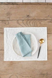 Set of 2 MagicLinen napkins on a table with a spoon, showcasing premium 100% linen table decor from Athens Cooks.