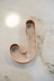 Galley and Fen - Christmas Cookie Cutters - Set of 6: Copper J cutter on stone surface, ideal for festive baking with clean cuts and easy dough release.