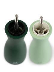 Peugeot | Tahiti Duo Salt + Pepper Mills with visible grinding mechanisms and caps removed, showcasing elegant design in dark and mint green tones.