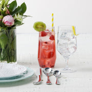Zwiesel Fortessa | Tritan Outdoor Iced Tea Tumbler featured on a summery table with pink blooms, flatware, and refreshing drinks, ideal for outdoor dining.