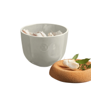 Emile Henry | Garlic Pot - Clay, featuring a ceramic bowl with ventilation holes for storing garlic, topped by a cork lid for optimal preservation.