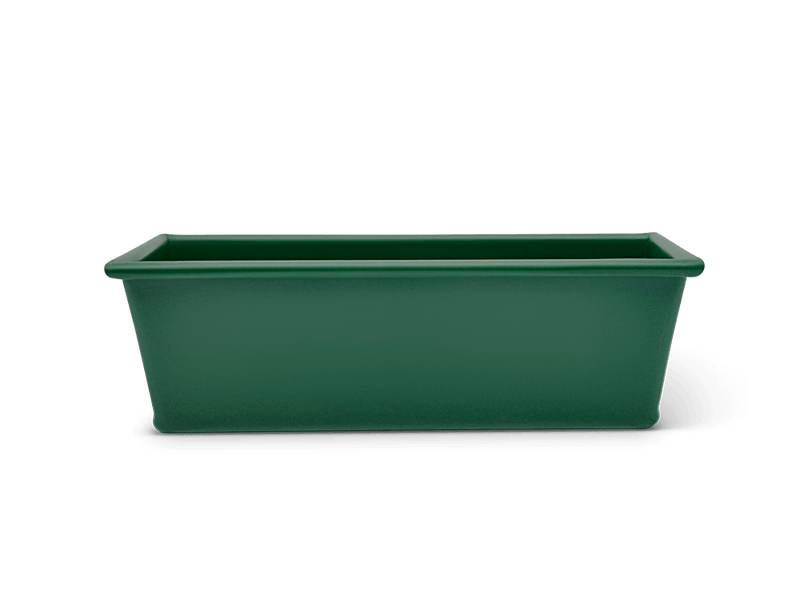 Great Jones | Breadwinner - Raspberry loaf pan with a nonstick, wavy ceramic design, ideal for flawless baking and easy release of bread.