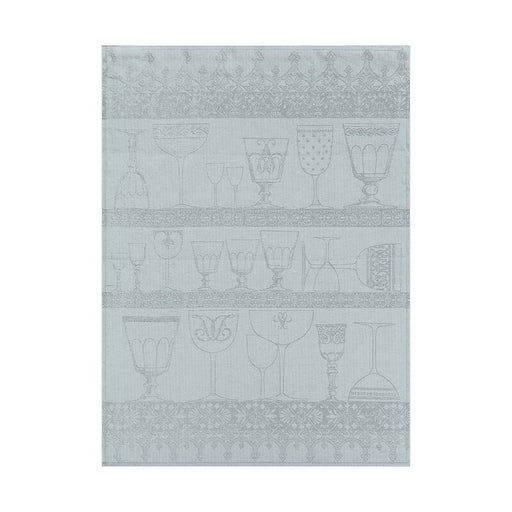 Le Jacquard Français | Cristal Tea Towel, Mist: A decorative linen towel featuring light blue/gray illustrated glassware on shelves with ornamental borders, ideal for drying delicate dishes.