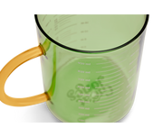 Great Jones | Beyond Measure 4-Cup - Broccoli-Butternut, a sturdy borosilicate glass measuring cup with clear measurements and a precision-pour spout, ideal for kitchen prep and entertaining.