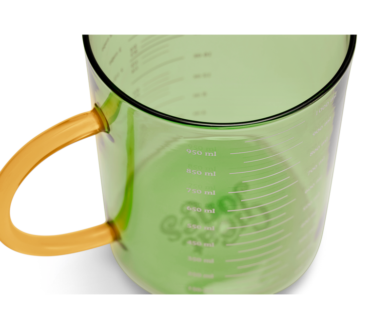 Great Jones | Beyond Measure 4-Cup - Broccoli-Butternut, a sturdy borosilicate glass measuring cup with clear measurements and a precision-pour spout, ideal for kitchen prep and entertaining.