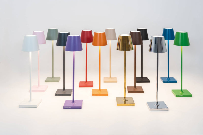 Zafferano America - Poldina Pro Micro Cordless Lamp: Sand, featuring touch dimming and a die-cast aluminum body, displayed among vibrant lamp designs.
