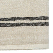Close-up of Caravan Home | Vintage Linen Natural & Black Towels, showcasing handmade, woven texture with black stripes, ideal for adding elegance to dining settings.