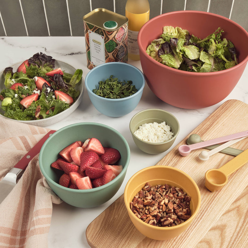 Bamboozle - 5-Piece Astrik Mixing Bowl Set: Fresh Guacamole on a table with assorted foods, showcasing eco-friendly kitchenware ideal for culinary creations.