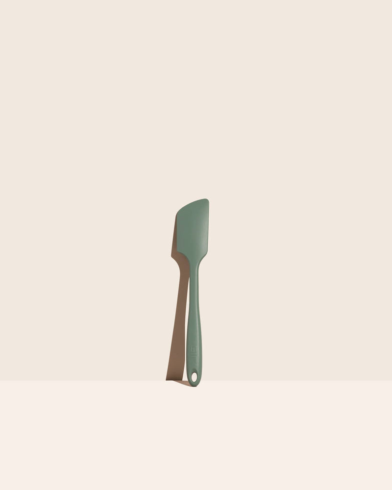 GIR Get It Right - GIR Ultimate Spatula: Sage on a white surface; a versatile, heat-resistant kitchen tool ideal for mixing and maneuvering, featuring a seamless, hygienic design.
