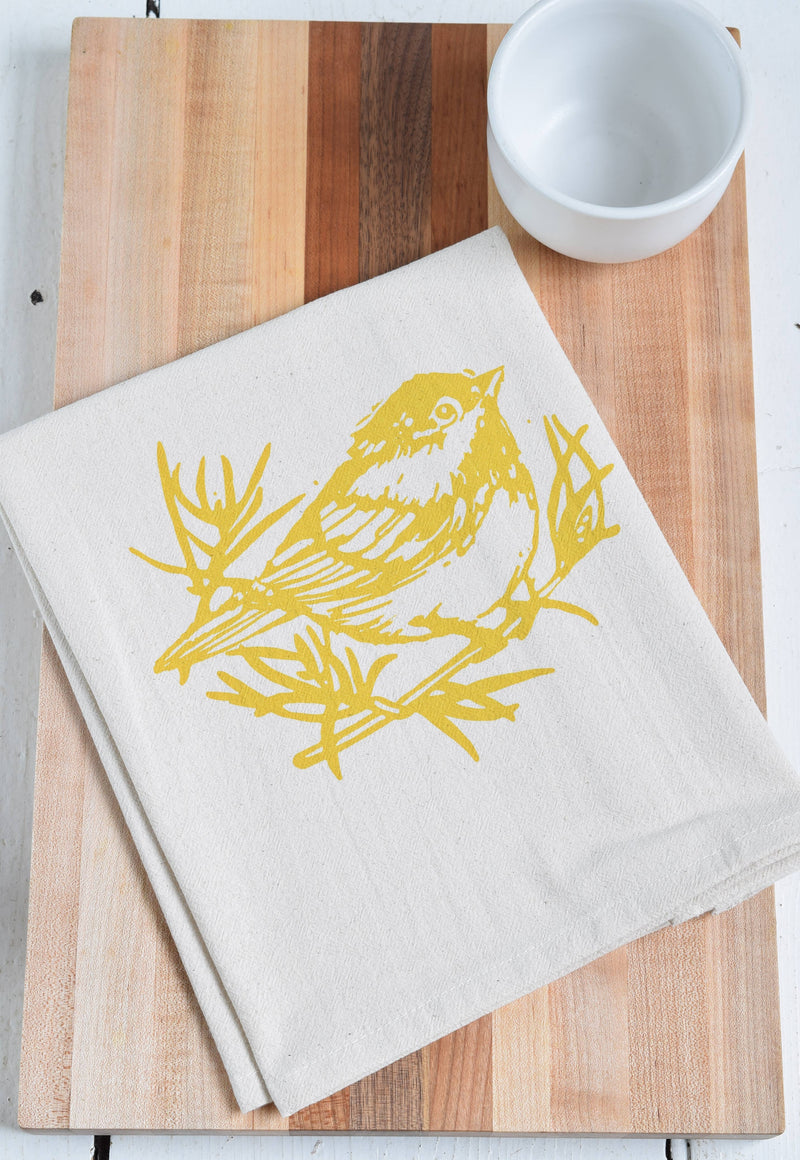 Hearth and Harrow - Set of 4 Organic Cotton Chickadee Cloth Napkins in Yellow, featuring a hand-printed bird design, displayed on a wooden surface.