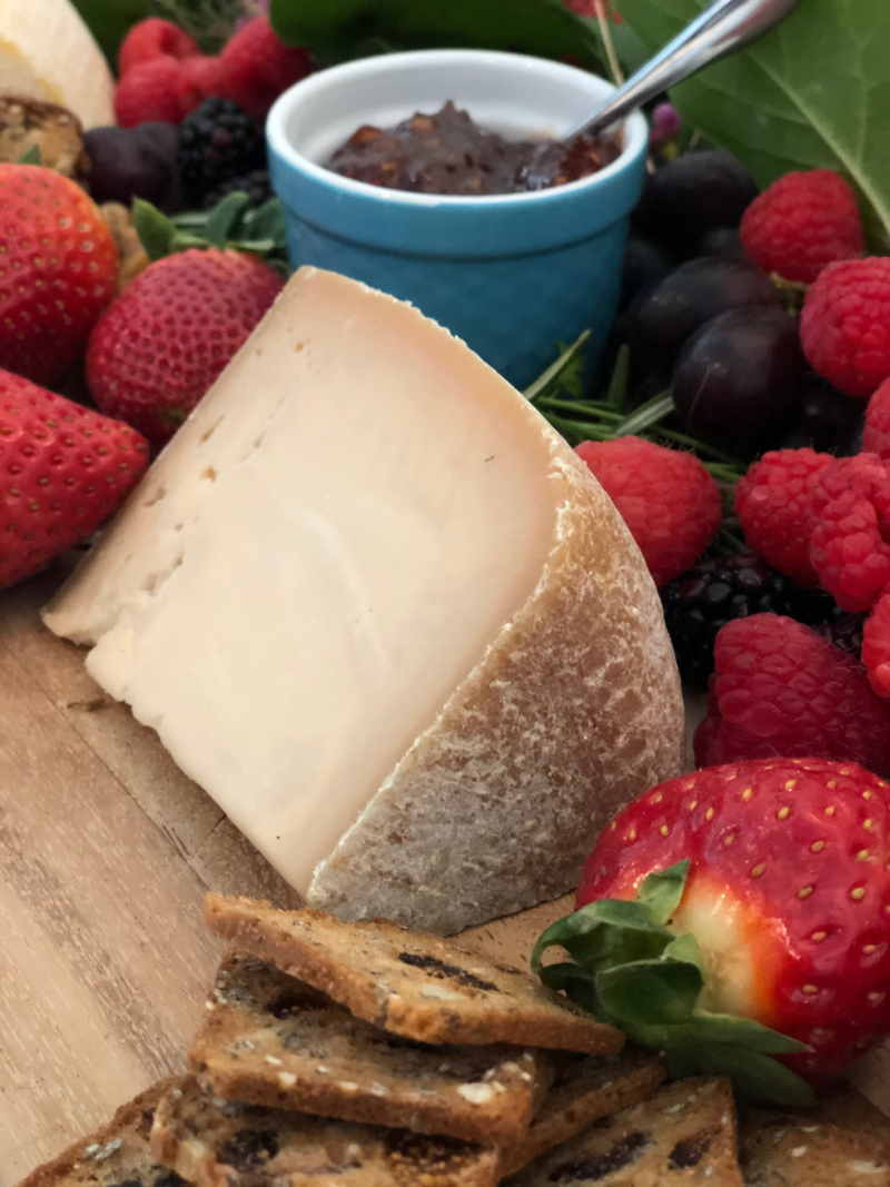 Tulip Tree Creamery - Hops: 5 Oz. Wedge, a double cream cheese, accompanied by strawberries and crackers, perfect for pairing with wine or beer.