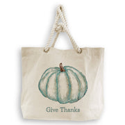 French Graffiti - Blue Pumpkin: Natural tote bag with twisted rope handles, featuring a teal watercolor pumpkin and Give Thanks text, ideal for kitchen-themed gifts.