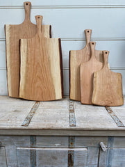 Petermans Boards and Bowls Inc. 18 Cherry Serving Board with Handle, handcrafted from upcycled cherry logs, showcasing a smooth, satiny grain for elegant kitchen presentation.