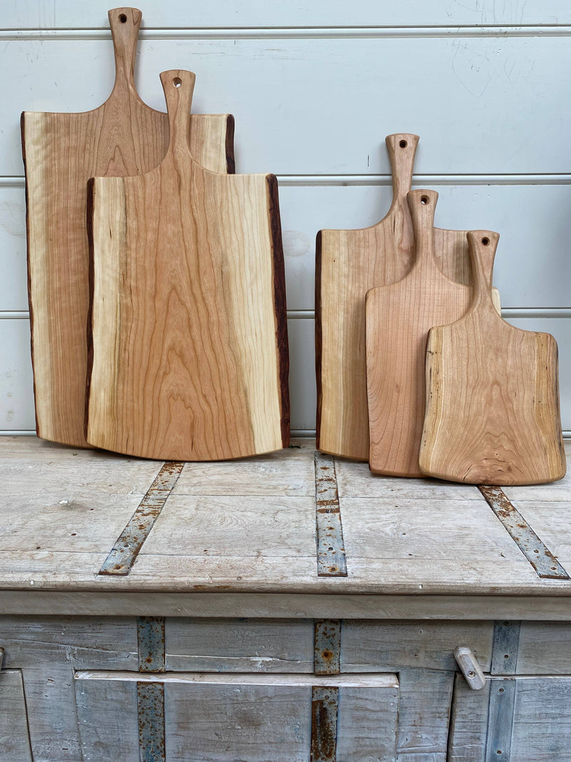 Petermans Boards and Bowls Inc. 18 Cherry Serving Board with Handle, handcrafted from upcycled cherry logs, showcasing a smooth, satiny grain for elegant kitchen presentation.