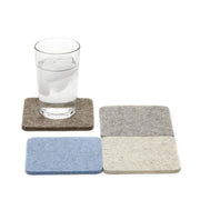 Glass of water on Graf Lantz - Bierfilzl Merino Wool Felt Square Coaster Multi 4 Pack, showcasing durable, stylish coasters ideal for kitchen use.