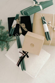 Mo&Co Home - Forest Green | Dipped Beeswax Taper Candles, bundled under ribbons on festive gift boxes, showcasing holiday-ready elegance and eco-conscious craftsmanship.