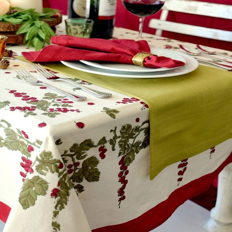 Couleur Nature - Gooseberry Red & Green tablecloth elegantly set with a festive place setting, embodying rustic charm and crafted for versatile dining experiences.