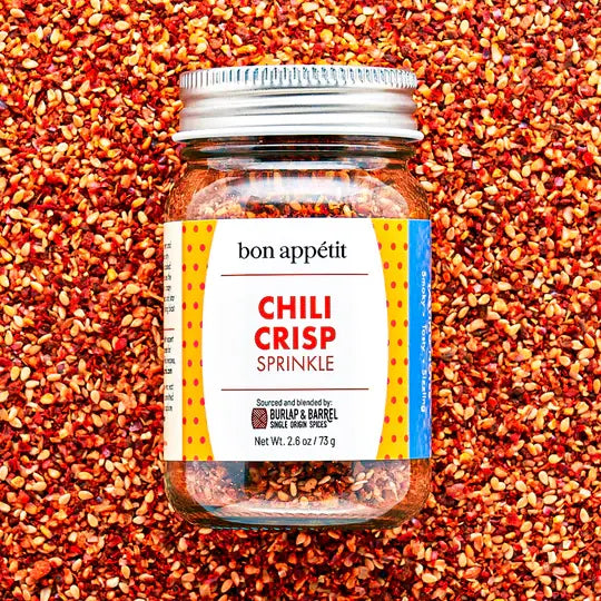 Burlap & Barrel - Chili Crisp Sprinkle, a 2.6 oz spice blend jar with dried chili flakes and crunchy bits, perfect for enhancing dishes with smoky-sweet flavor.
