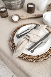Set of 2 linen napkins on a plate with silverware, showcasing MagicLinen's durable, stone-washed table decor, ideal for versatile kitchen settings.