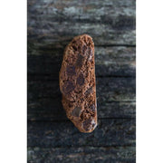 Zia Pia | Biscotti by Fratelli Lunardi - Lemon, a close-up of a chocolate chip cookie on wood, showcasing its traditional Tuscan craftsmanship and premium ingredients.