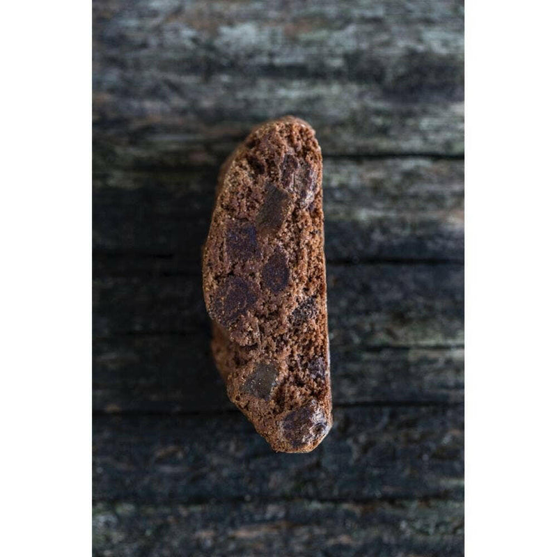 Zia Pia | Biscotti by Fratelli Lunardi - Lemon, a close-up of a chocolate chip cookie on wood, showcasing its traditional Tuscan craftsmanship and premium ingredients.